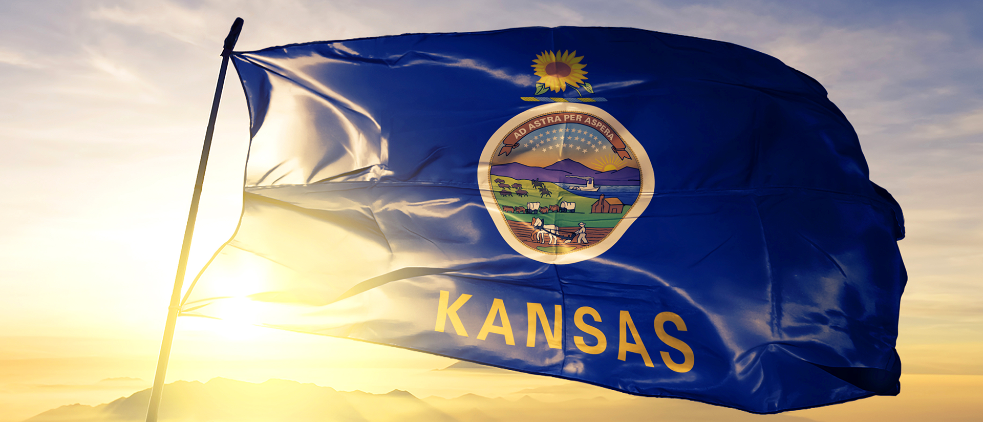 Kansas Flag blowing in the wind during sunset
